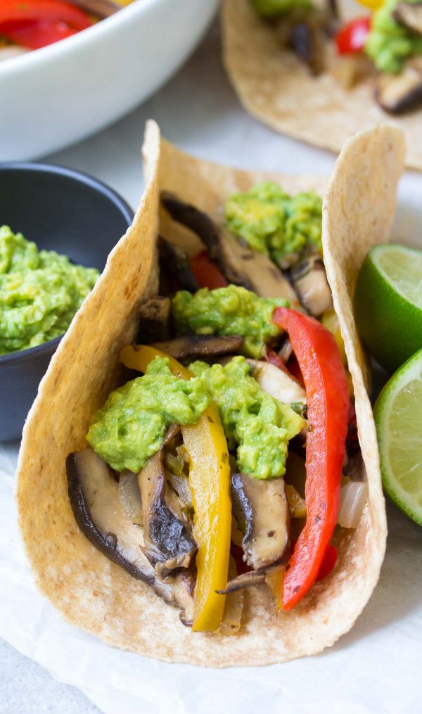 These Vegetarian Portobello Mushroom Fajitas are a 30 minute meal that you can prep ahead. With guacamole, these healthy vegan fajitas are hard to resist! | www.kristineskitchenblog.com