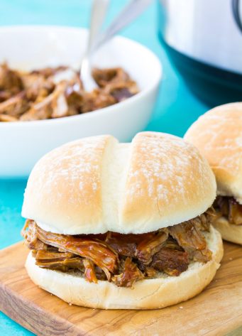 This Instant Pot Pulled Pork is the most amazing, tender, fall apart pulled pork you will ever eat! I'll teach you how to make my best pulled pork sandwiches for your family's dinner. You can make this easy pulled pork recipe in your slow cooker, too!