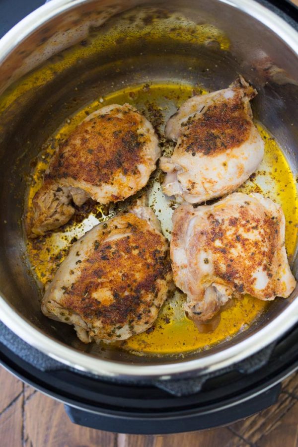 Easy Instant Pot Chicken Thighs with the best seasoning! How to cook perfectly moist and juicy chicken thighs in your Instant Pot pressure cooker. From fresh or frozen. Use boneless, skinless thighs or bone in. One of our favorite healthy chicken recipes! Browning chicken thighs in an Instant Pot.