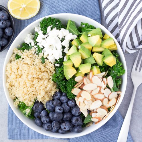 This Kale Superfood Salad with Quinoa and Blueberries is loaded with super foods! This healthy salad is make ahead friendly for quick lunches. Goat cheese, avocado, and a honey lemon dressing bring lots of flavor to this gluten free power salad! kristineskitchenblog.com