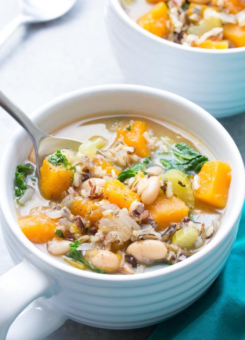 Slow Cooker Wild Rice Vegetable Soup in a soup bowl with a spoon.
