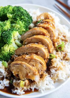 Sliced chicken with honey garlic sauce served with rice and broccoli.