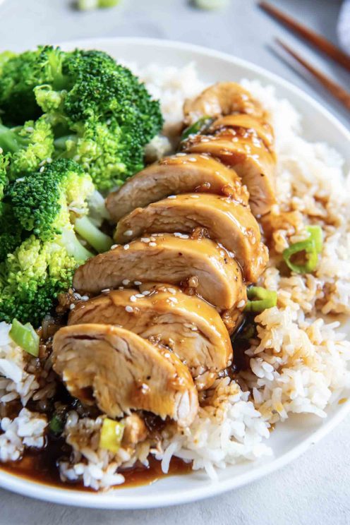 Sliced chicken with honey garlic sauce served with rice and broccoli.