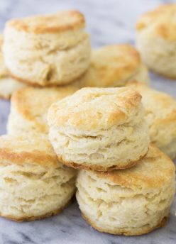 Biscuits stacked together on marble board.