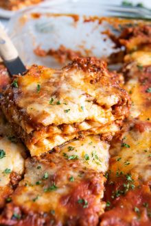 Baked lasagna cut into slices in the pan.