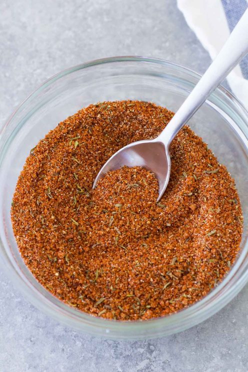 Pork rub in a small glass bowl with a spoon.