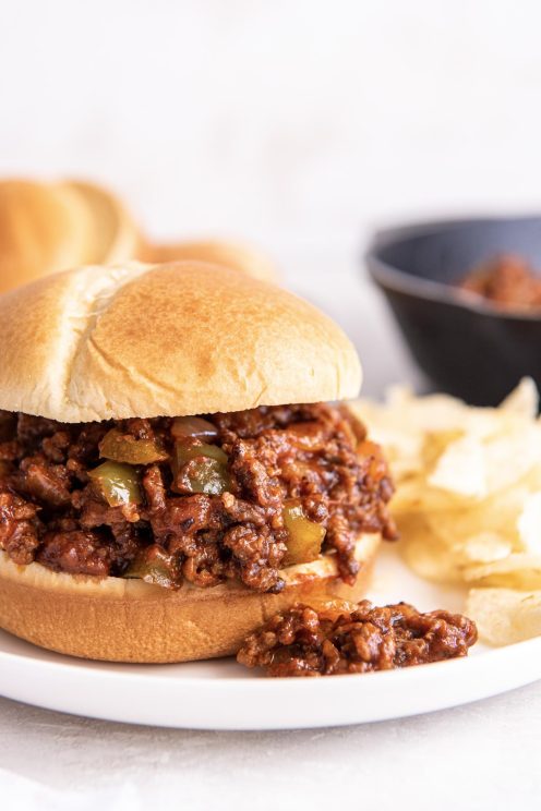 Side view of sloppy joes served on a burger bun.