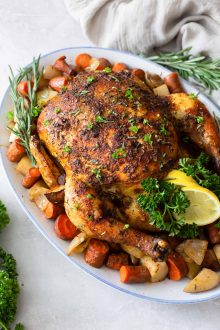crockpot whole chicken and vegetables on a serving platter