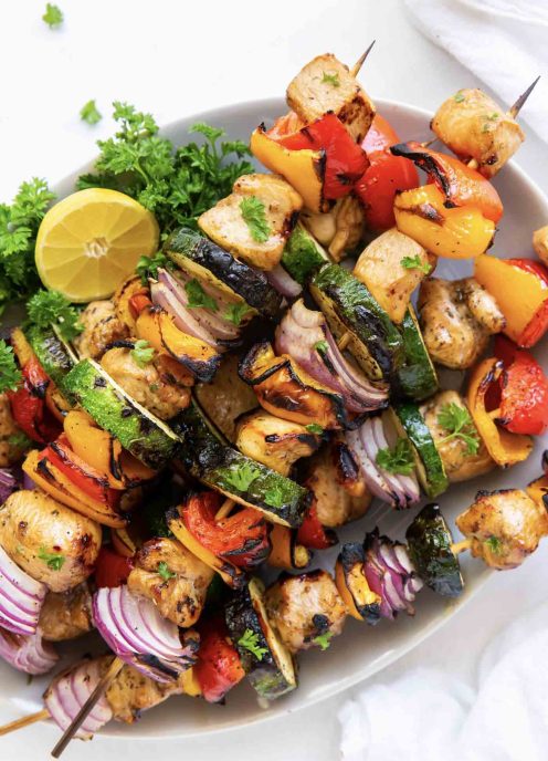 Grilled chicken kabobs on a plate.