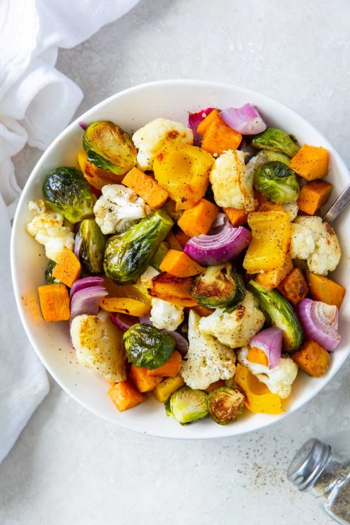 Roasted vegetables in a white serving bowl.