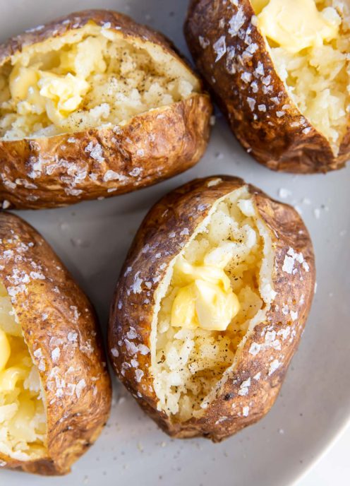 Baked potato topped with butter, salt and pepper.