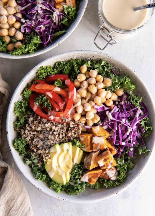 Buddha bowl with quinoa, chickpeas, roasted sweet potatoes and tahini dressing.