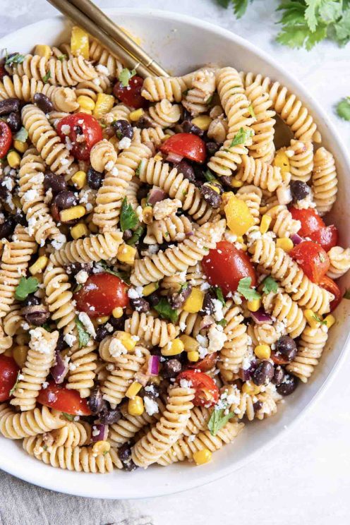 Southwest pasta salad in serving bowl with spoon.