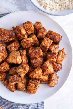 Air fryer salmon bites stacked on a plate.