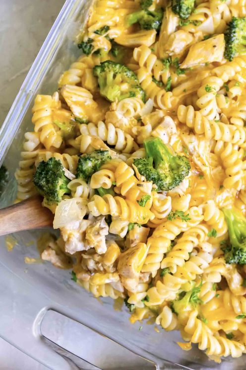 Chicken noodle casserole in a baking dish with a wooden spoon.