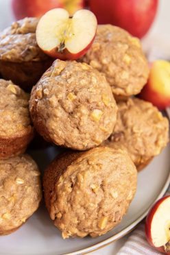 Apple oatmeal muffins stacked on a plate.