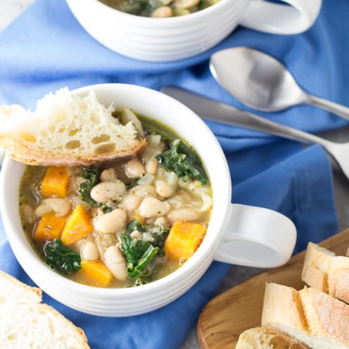 This healthy 30 Minute Tuscan White Bean and Kale Soup is vegetarian, vegan, and so easy to make! It's a warm and comforting dinner that reheats wonderfully for lunch!